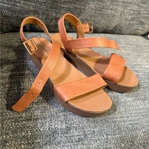 Brown strap sandals. Has normal wear on them.